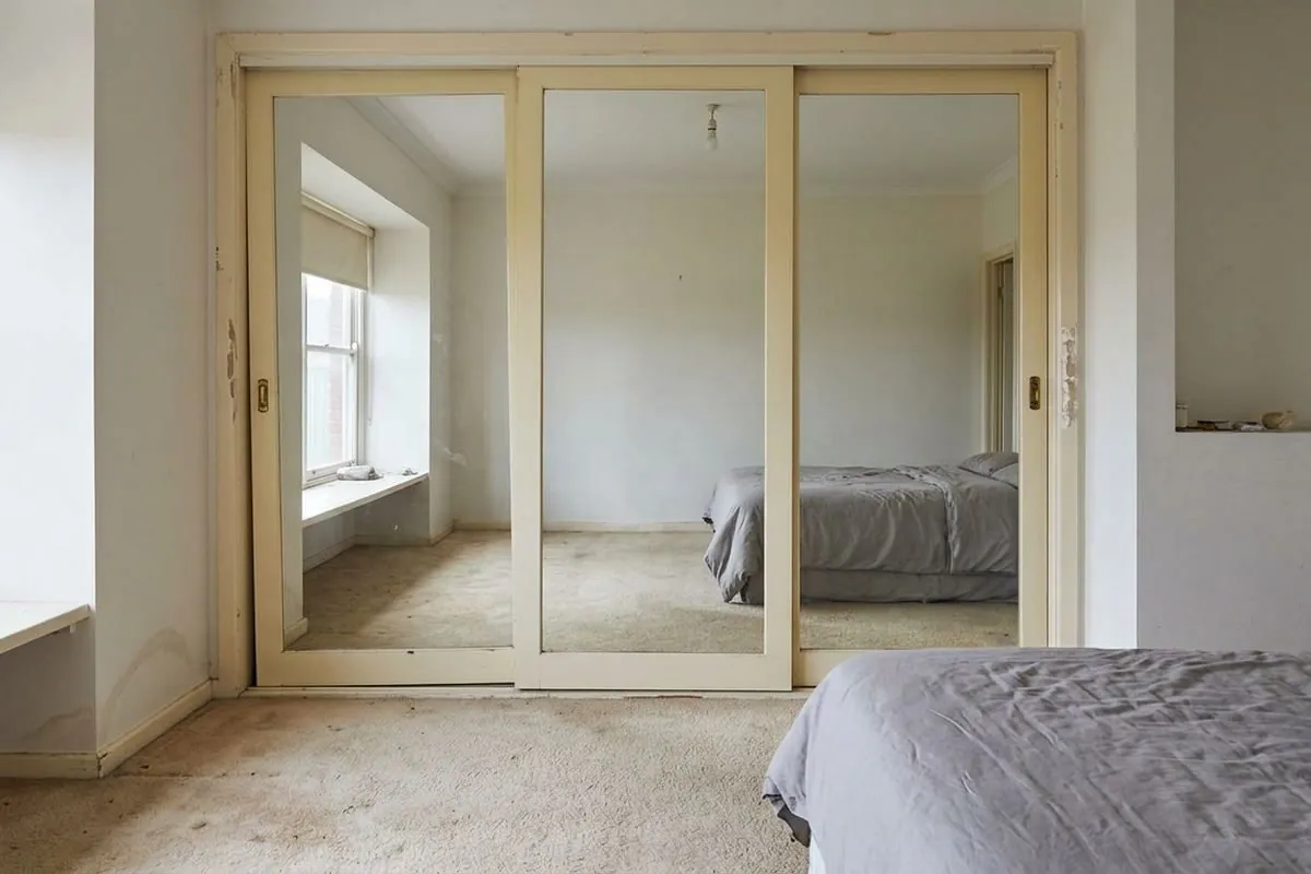 Before: a tired cream-framed built-in wardrobe